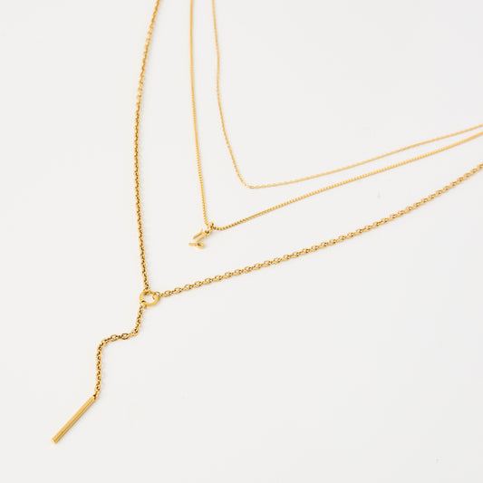 Three gold necklaces on a white background