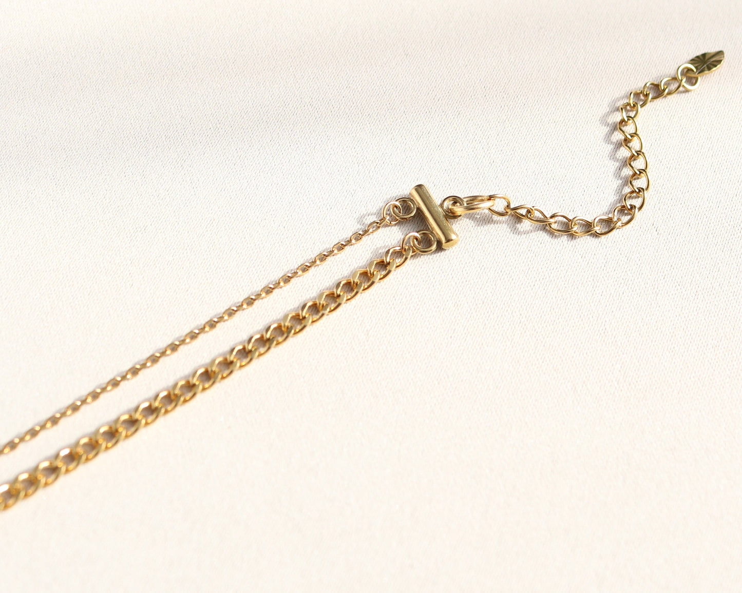 Gold chain necklace on a white background
